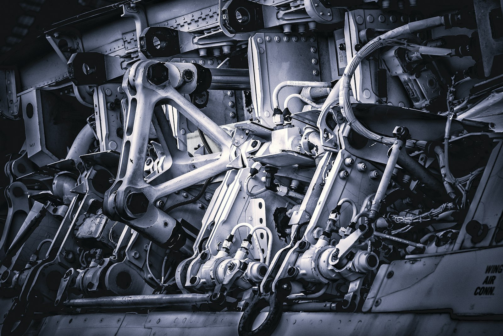 Identical machined metal parts laid out together on a workbench